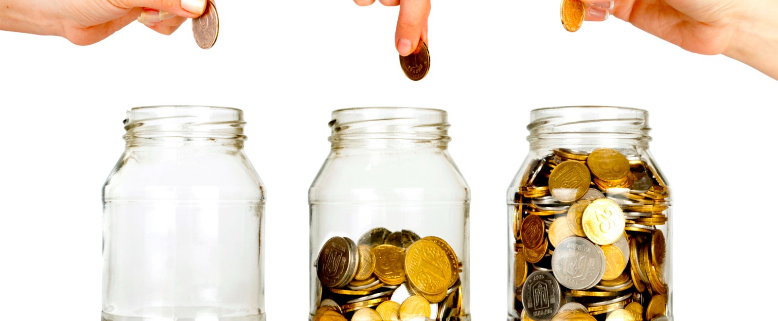 hands putting coins in glass jars