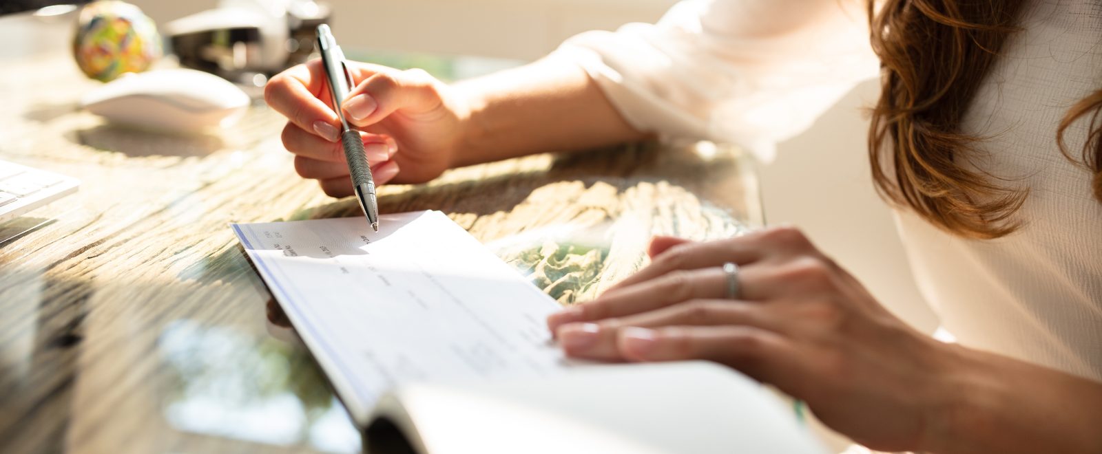 a person writing on a business check