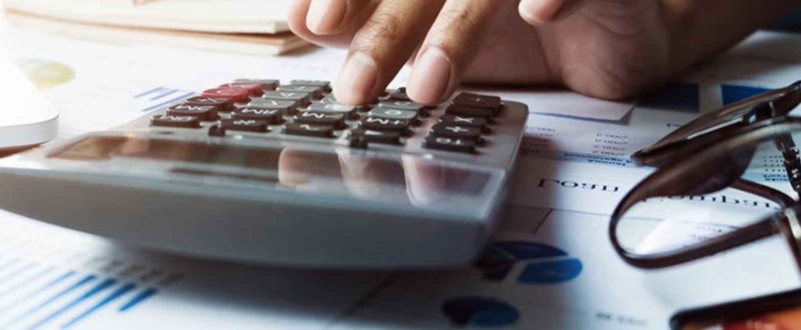 a person working on a financial calculator