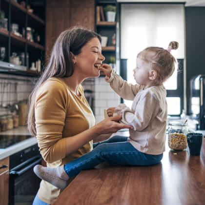 A mom and toddler in the kitchen